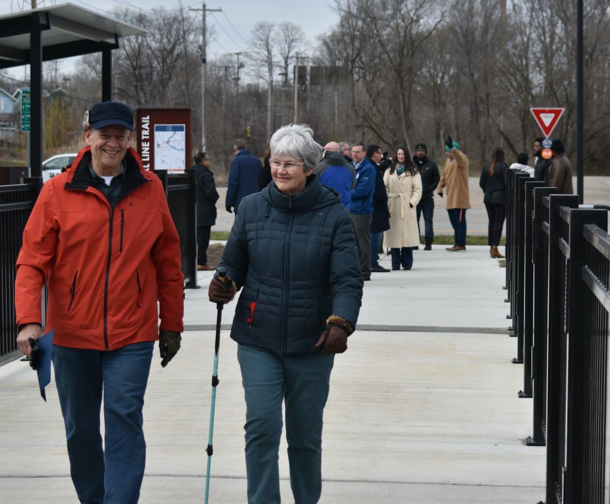Former South Bend Mayor Stephen Luecke walks across a bridge on the newly named Stephen J. Luecke Coal Line Trail with his wife, Peg Luecke, on Thursday, March 21, 2024. The couple often take trips on a tandem bicycle.