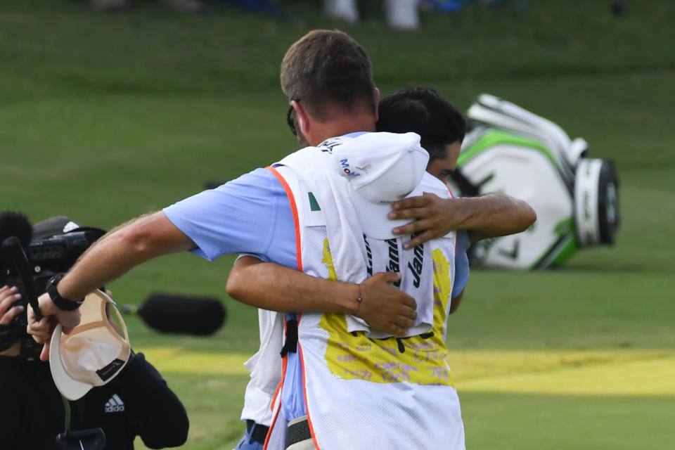 Abraham Ancer hugs his caddie after winning the World Golf Championship-FedEx St. Jude Invitational tournament, Sunday, Aug. 8, 2021, in Memphis, Tenn. (AP Photo/John Amis)