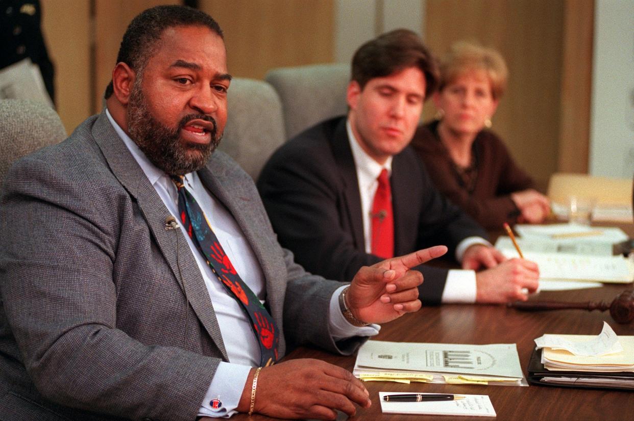 Columbus Public Schools Superintendent Larry Mixon, left, makes a point in this file photo from a 1997 meeting as school board president Mark Hatch and board member Karen Schwarzwalder look on.