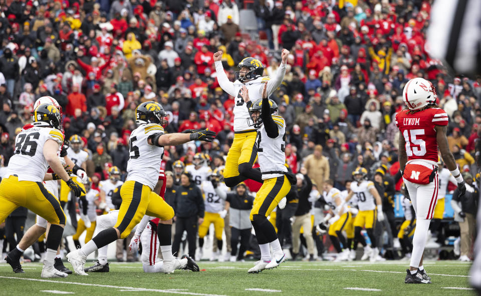 Iowa kicker Marshall Meeder, second right, celebrates with Steven Stilianos, from left, Logan Lee and Tory Taylor after Meeder kicked a last-second field goal to win against Nebraska during an NCAA college football game Friday, Nov. 24, 2023, in Lincoln, Neb. (AP Photo/Rebecca S. Gratz)