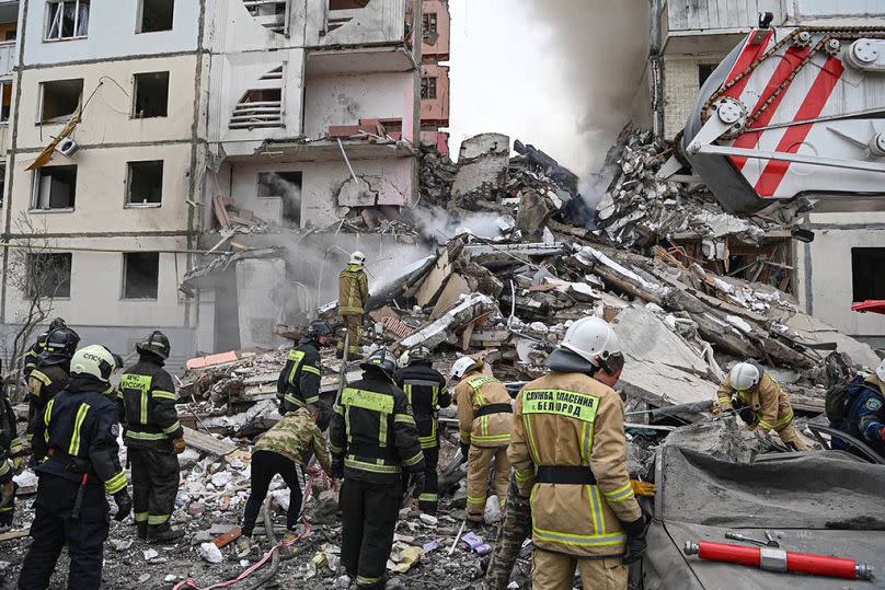 Russian emergency service employees work at the scene of a partially collapsed block of flats after a missile attack by the Ukrainian Armed Forces in Belgorod