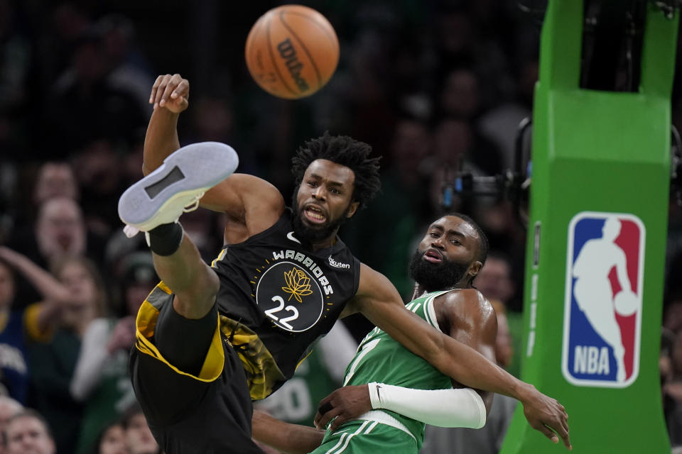 Golden State Warriors forward Andrew Wiggins (22) and Boston Celtics guard Jaylen Brown (7) vie for control of the ball in the second half of an NBA basketball game, Thursday, Jan. 19, 2023, in Boston. (AP Photo/Steven Senne)