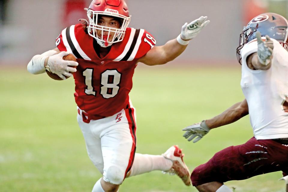 Koa Rapolla (18) runs the ball during the first football game of the year against Granite Hills in Palm Springs, Calif., on Friday, August 18, 2023.