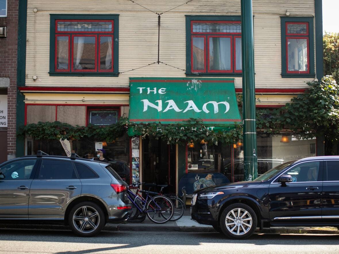 The Naam vegetarian restaurant in Vancouver has been listed for sale for nearly $8 million, including the property which has a two-bedroom upstairs suite. The possibility of a sale puts the future of the decades-old vegetarian institution in Vancouver's Kitsilano neighbourhood in question. (Ben Nelms/CBC - image credit)