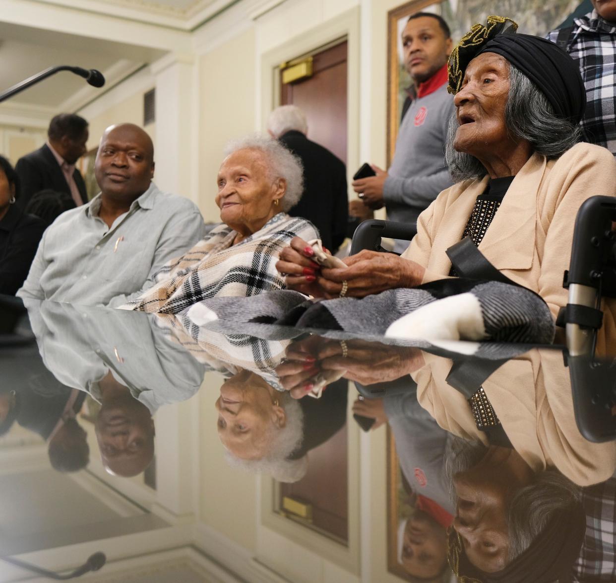 Ike Howard, left, looks at his grandmother, Viola Ford Fletcher, 109, as she and Lessie Benningfield Randle, 108, right, are introduced Thursday during the House General Government Committee meeting at the Oklahoma Capitol.