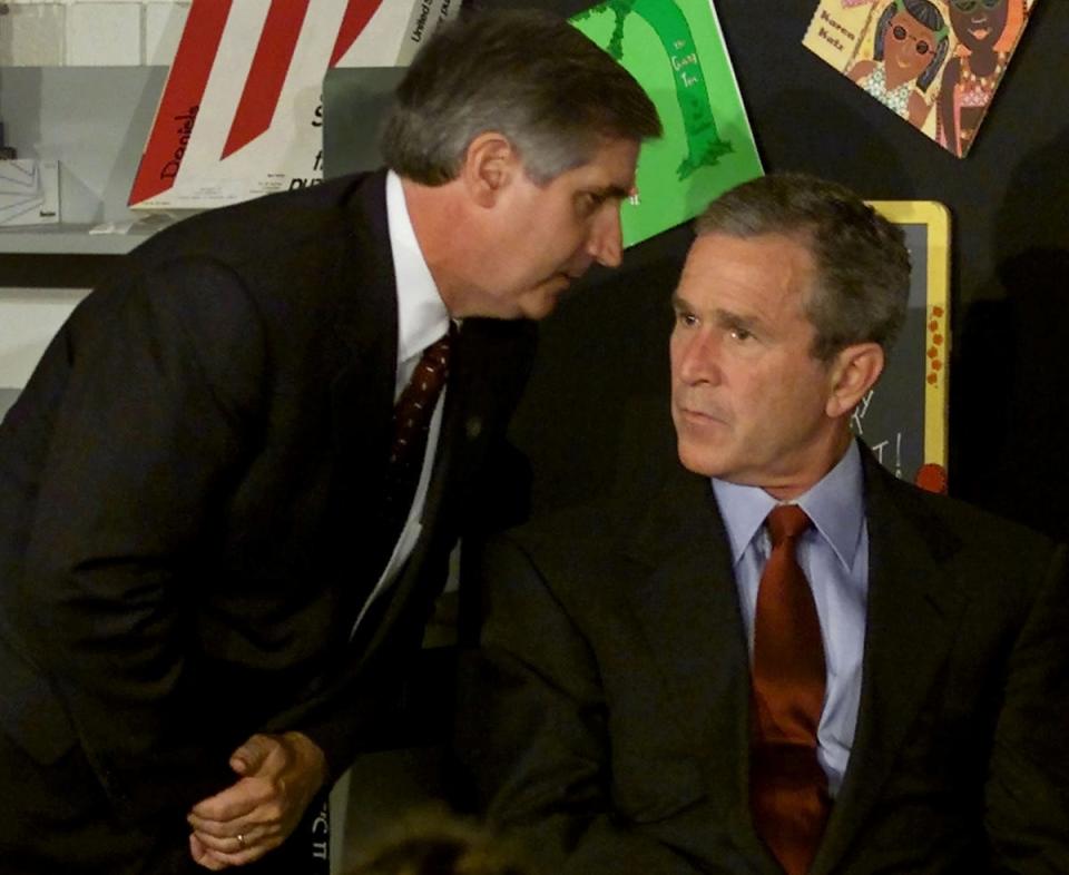 US President George W Bush listens as White House Chief of Staff Andrew Card informs him of a second plane hitting the World Trade Center. Bush was conducting a reading seminar at the Emma E Booker Elementary School, in Sarasota, Florida (Reuters)