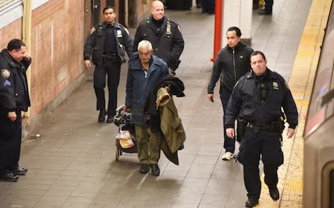 The man leaves the station in the company of police officers - Credit: Christopher Sadowski