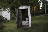 An outhouse stands behind a building in Rendville, Ohio, on Sunday, July 26, 2020. Such toilets were once common in some towns until fairly recently and are becoming increasingly rare. (AP Photo/Wong Maye-E)