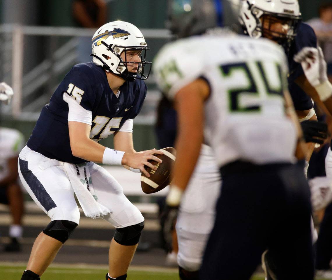 Keller quarterback Beckham Robinson (15) takes the snap in the first half of a UIL high school football game at Keller ISD Stadium in Keller, Texas, Friday, Sept. 15, 2023. Keller led Eaton 31-14 at the half.