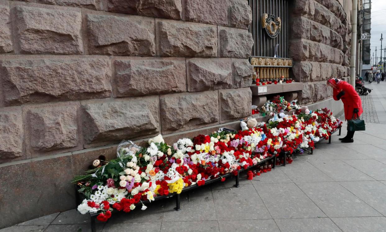 <span>A woman stands at a memorial in Moscow to the victims of the Islamic State terrorist attack at the Crocus City Hall.</span><span>Photograph: Anatoly Maltsev/EPA</span>