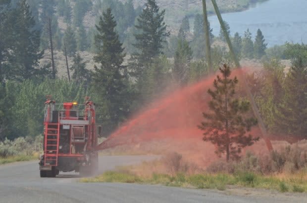 Crews work to extinguish the Tremont Creek wildfire.  (B.C. Wildfire Service/Twitter - image credit)