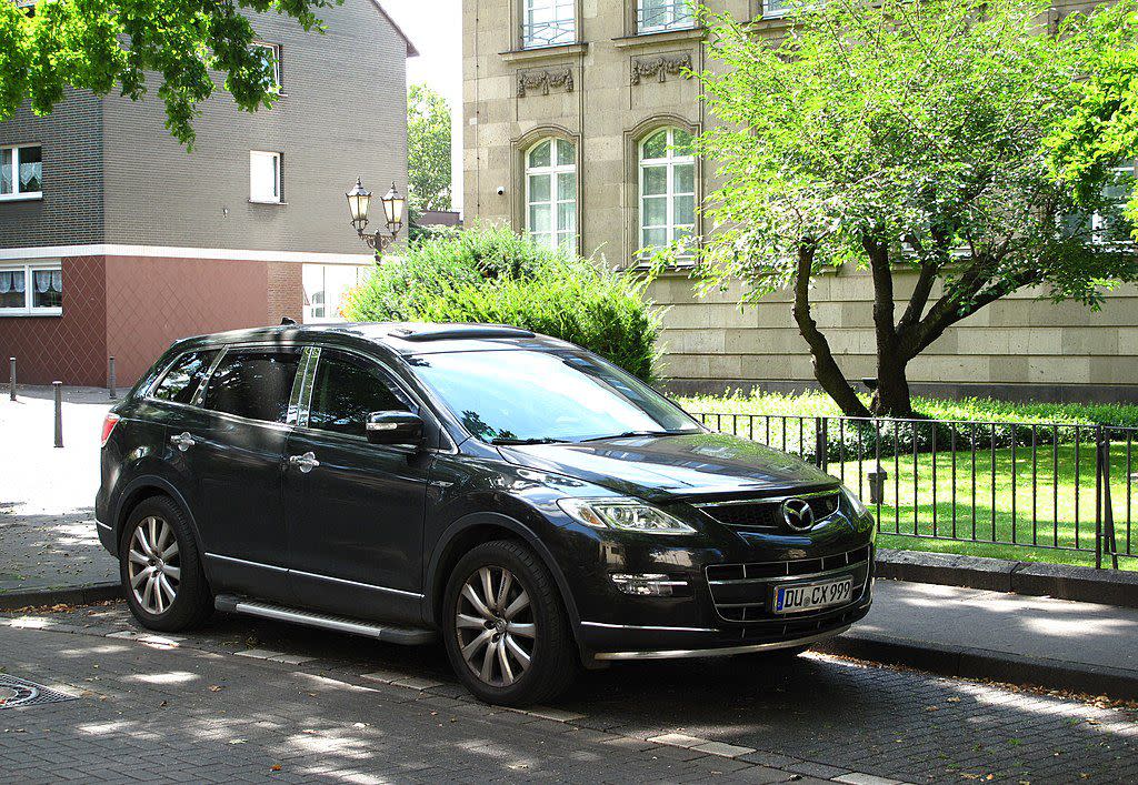 Navy Mazda CX-9 parked on street in summer