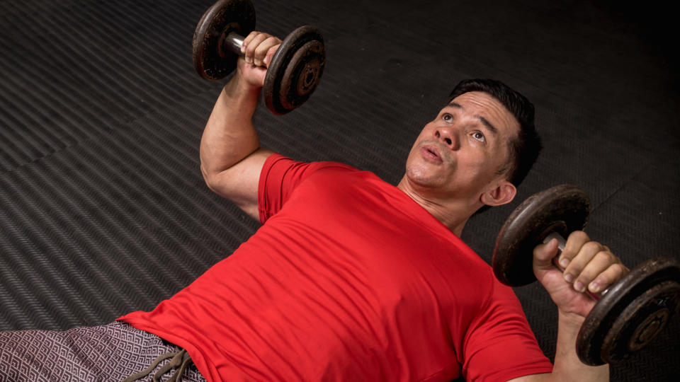 Man performing a dumbbell chest press