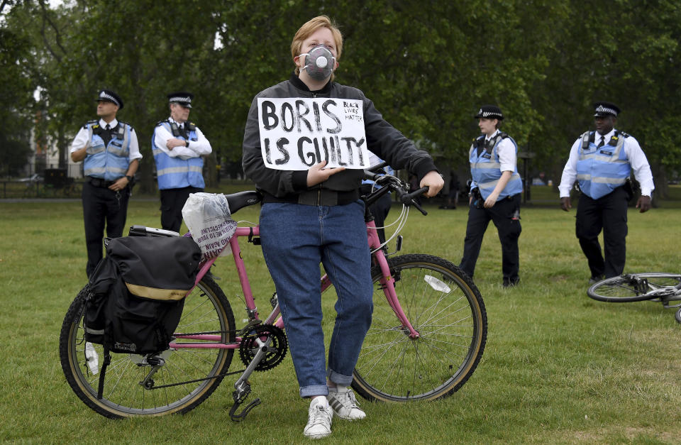 A protestor rests on his bicycle during protests in London, Friday, June 12, 2020 in response to the recent killing of George Floyd by police officers in Minneapolis, USA, that has led to protests in many countries and across the US.(AP Photo/Alberto Pezzali)