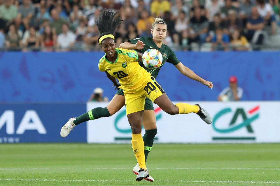 Jamaica's Cheyna Matthews, foreground, fights for the ball with Australia's Steph Catley during the Women's World Cup Group C soccer match between Jamaica and Australia at Stade des Alpes stadium in Grenoble, France, Tuesday, June 18, 2019.