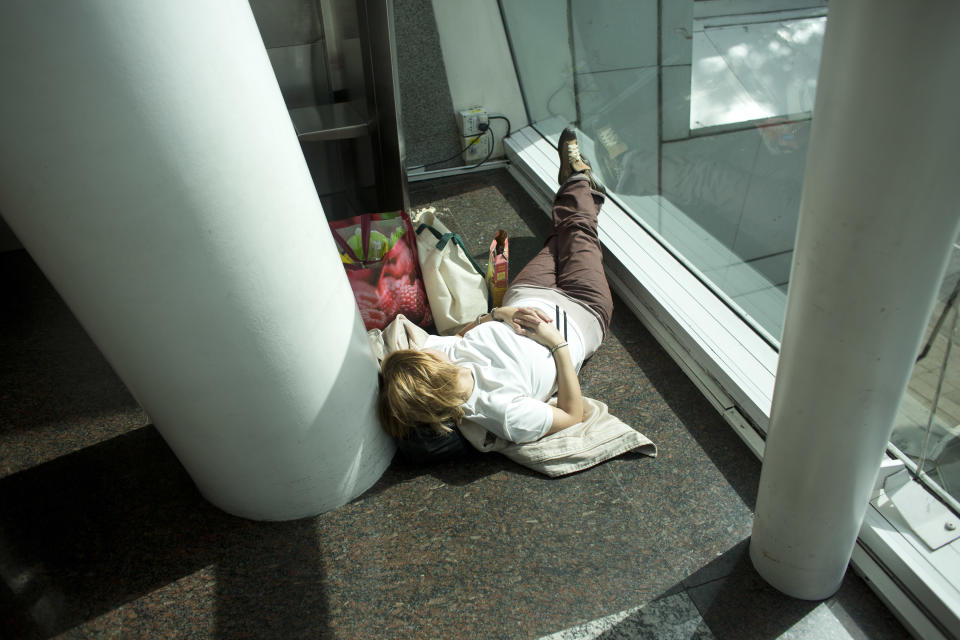 A stranded passenger sleeps at the Aeroparque city airport in Buenos Aires, Argentina, Thursday, April 10, 2014. A nationwide strike has paralyzed Argentina's economy, shutting down air, train and bus traffic while also closing businesses, public schools and ports. Union chiefs want higher pay and lower taxes. All Argentines are struggling with 30 percent inflation. (AP Photo/Victor R. Caivano)