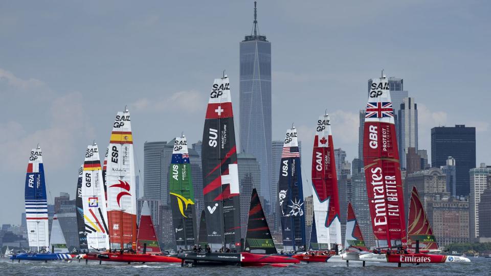 the fleet led by emirates great britain sailgp team ahead of canada sailgp team and usa sailgp team pass the one world trade centre and the new york city skyline on race day 2 of the mubadala new york sail grand prix in new york, usa sunday 23rd june 2024 photo bob martin for sailgp handout image supplied by sailgp