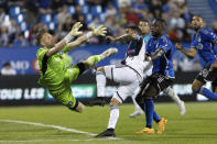 CF Montreal goalkeeper Jonathan Sirois, left, makes a save against Minnesota United midfielder Franco Fragapane, center, during second-half MLS soccer match action in Montreal, Saturday, June 10, 2023. (Evan Buhler/The Canadian Press via AP)