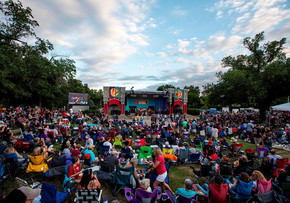 Crowds of people gather by the main stage at the Smoky Hill River Festival