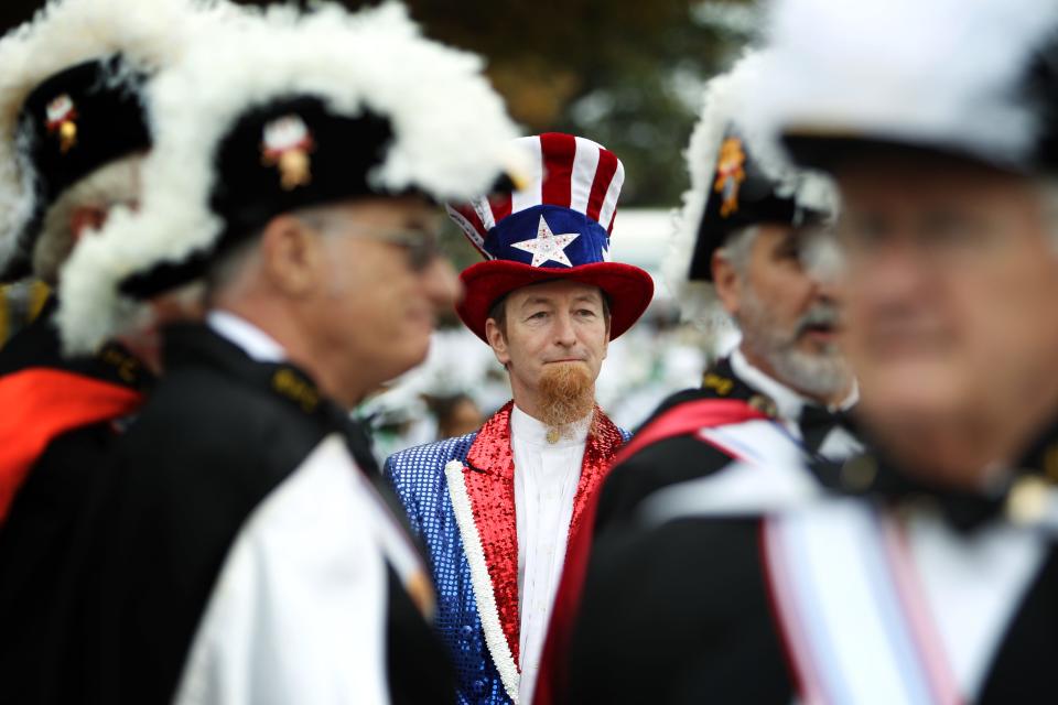 A man who would identify himself only as "Uncle Sam" stands with members of the Knights of Columbus before the start of the annual Memphis Veterans Day parade in 2014. Americans must realize we're all on the same team if we want the world’s oldest and boldest experiment in liberty to celebrate its 250th birthday.