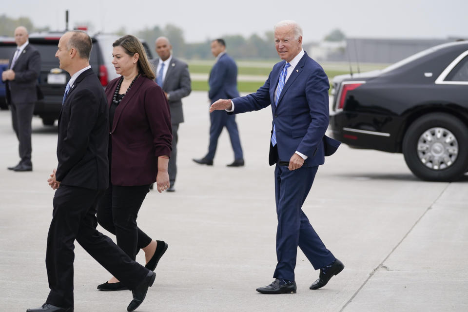 President Joe Biden walks with Rep. Elissa Slotkin, D-Mich., and Lansing Mayor Andy Schor as he arrives at Capital Region International Airport, Tuesday, Oct. 5, 2021, in Lansing, Mich. (AP Photo/Evan Vucci)