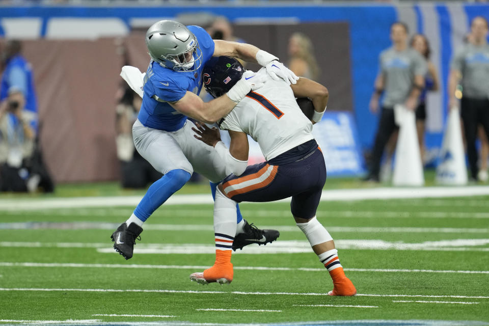 Detroit Lions defensive end Aidan Hutchinson tackles Chicago Bears quarterback Justin Fields (1) during the first half of an NFL football game, Sunday, Jan. 1, 2023, in Detroit. (AP Photo/Paul Sancya)