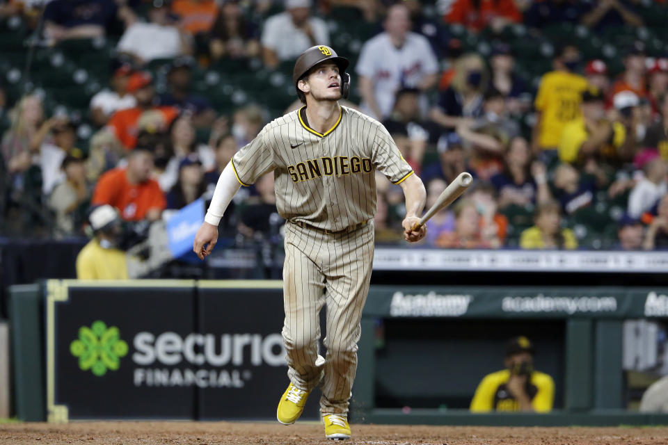 San Diego Padres' Wil Myers watches his three-run home run against the Houston Astros during the 12th inning of a baseball game Saturday, May 29, 2021, in Houston. (AP Photo/Michael Wyke)