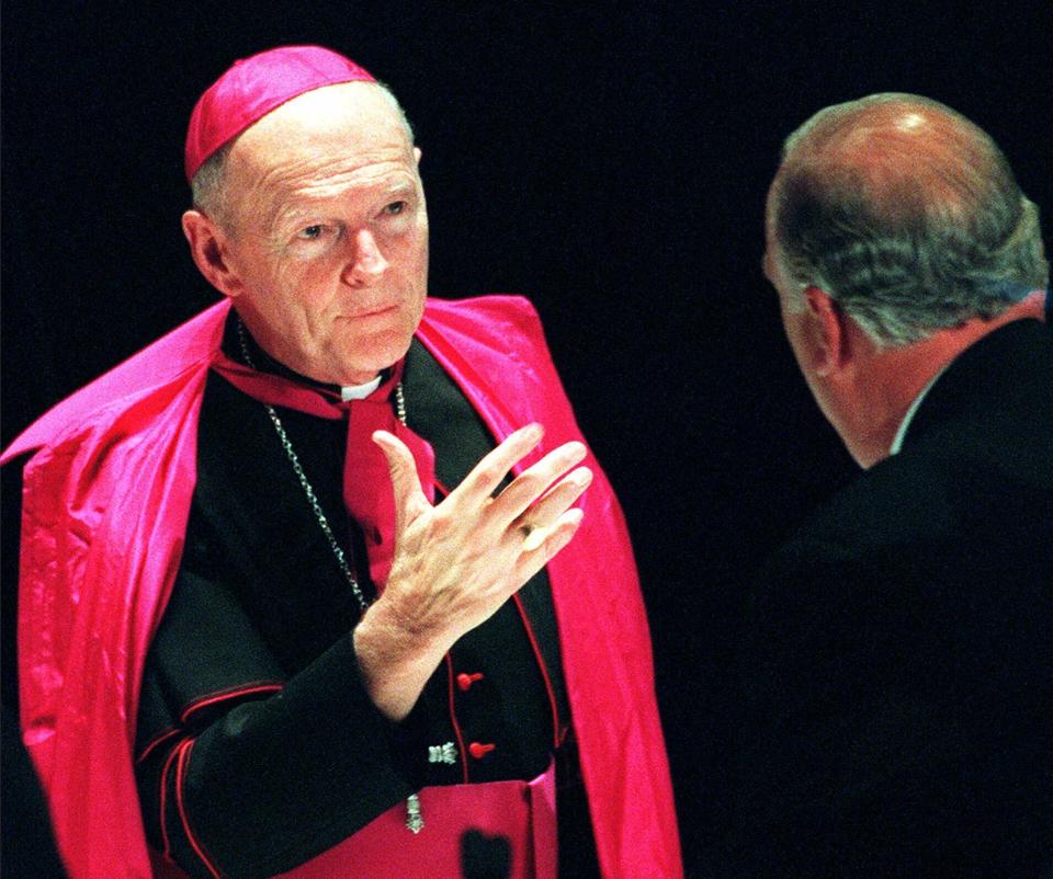 FILE - In this Jan. 15, 2000 file photo, Archbishop Theodore McCarrick, who heads the archdiocese for the U.S. military, speaks with a guest during Cardinal John O'Connor's 80th birthday party dinner at New York's Waldorf-Astoria hotel. On Tuesday, Nov. 10, 2020, the Vatican is taking the extraordinary step of publishing its two-year investigation into the disgraced ex-Cardinal McCarrick, who was defrocked in 2019 after the Vatican determined that years of rumors that he was a sexual predator were true. (AP Photo/Stuart Ramson, File)