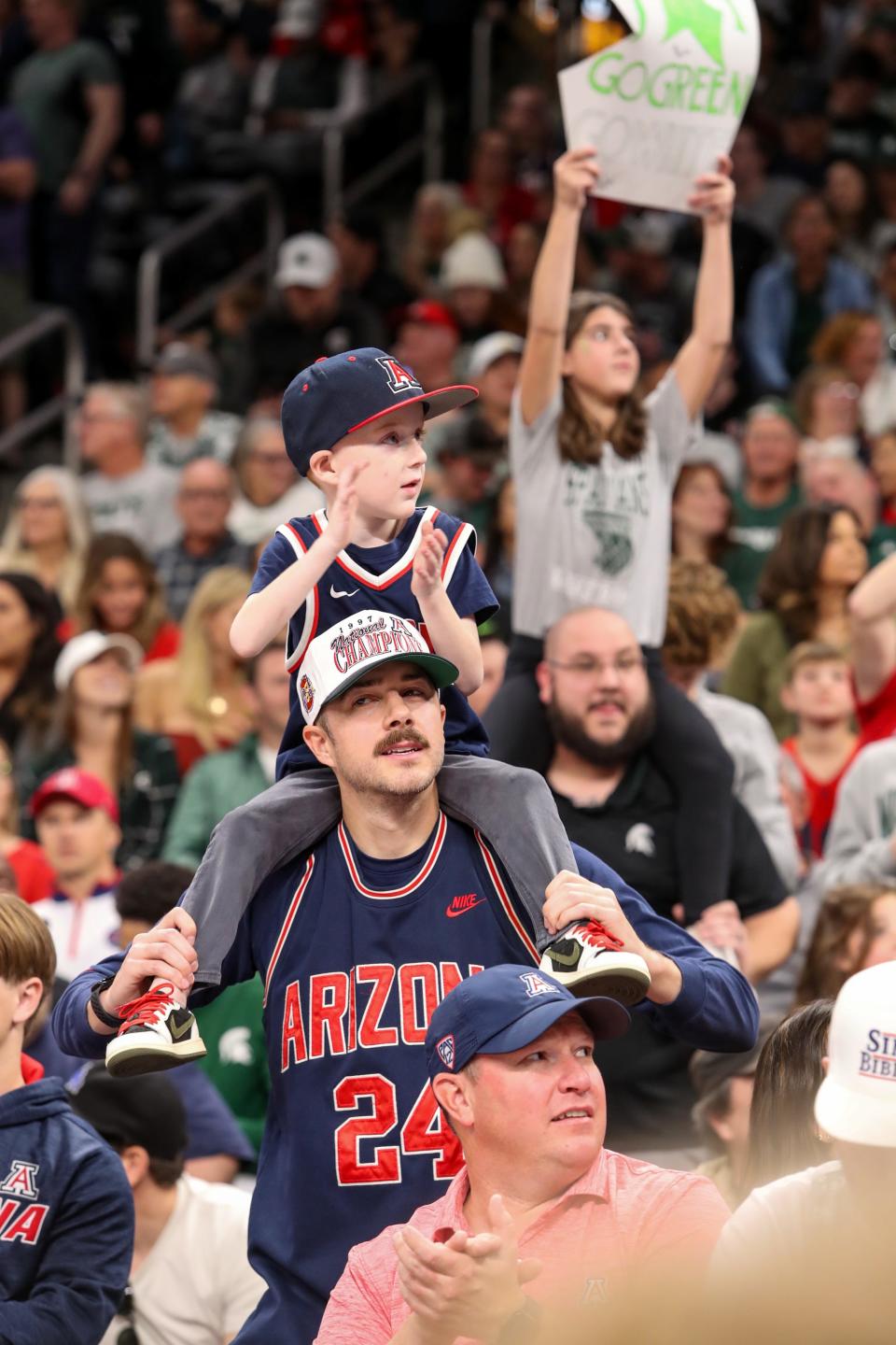 Arizona Wildcats fans Skylar Smith holds his son Beckham Smith, 5, on his shoulders during the first-ever Acrisure Classic against Michigan State in Palm Desert, Calif., on Thanksgiving Day, Nov. 23, 2023.