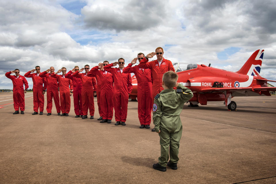 Jacob Newson, five, takes a salute from his heroes the Red Arrows pilots, at the Royal International Air Tattoo at RAF Fairford (Picture: UK MOD/Crown 2019)