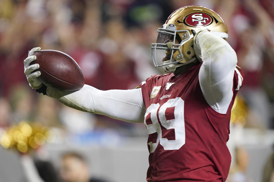 San Francisco 49ers defensive tackle DeForest Buckner (99) scores a touchdown against the Seattle Seahawks during the second half of an NFL football game in Santa Clara, Calif., Monday, Nov. 11, 2019. (AP Photo/Tony Avelar)