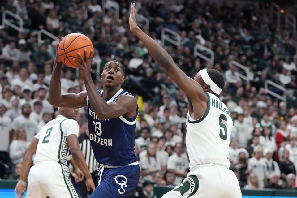 Georgia Southern guard Eren Banks (13) is defended by Michigan State guard Tre Holloman (5) during the first half of an NCAA college basketball game, Tuesday, Nov. 28, 2023, in East Lansing, Mich. (AP Photo/Carlos Osorio)