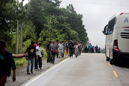 Honduran migrants try to hitchhike to get into the Agua Caliente border and hoping to cross into Guatemala and join a caravan trying to reach the U.S, in the municipality of Ocotepeque, Honduras October 17, 2018. REUTERS/Jorge Cabrera