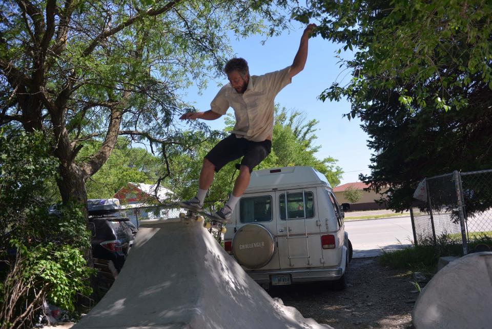 Clay Shank, the project manager for the Rosebud Skatepark Development Project performs a trick at the Oyate Park or Yellow House Skatepark in Mission, on Monday, June 19, 2023.