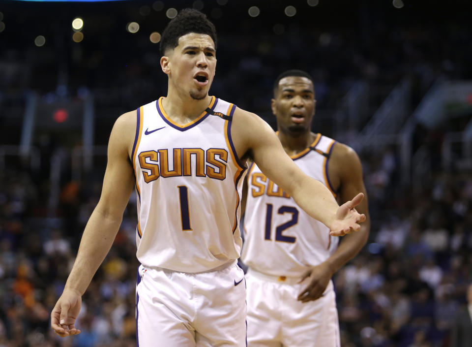 Suns guard Devin Booker may miss training camp with a hand injury. (Associated Press)