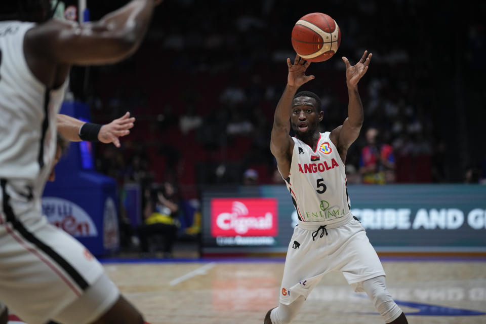 Angola guard Childe Dundao (5) passes to his teammate during their match against Italy Basketball World Cup at the Philippine Arena in Bulacan province, Philippines Friday, Aug. 25, 2023. (AP Photo/Aaron Favila)