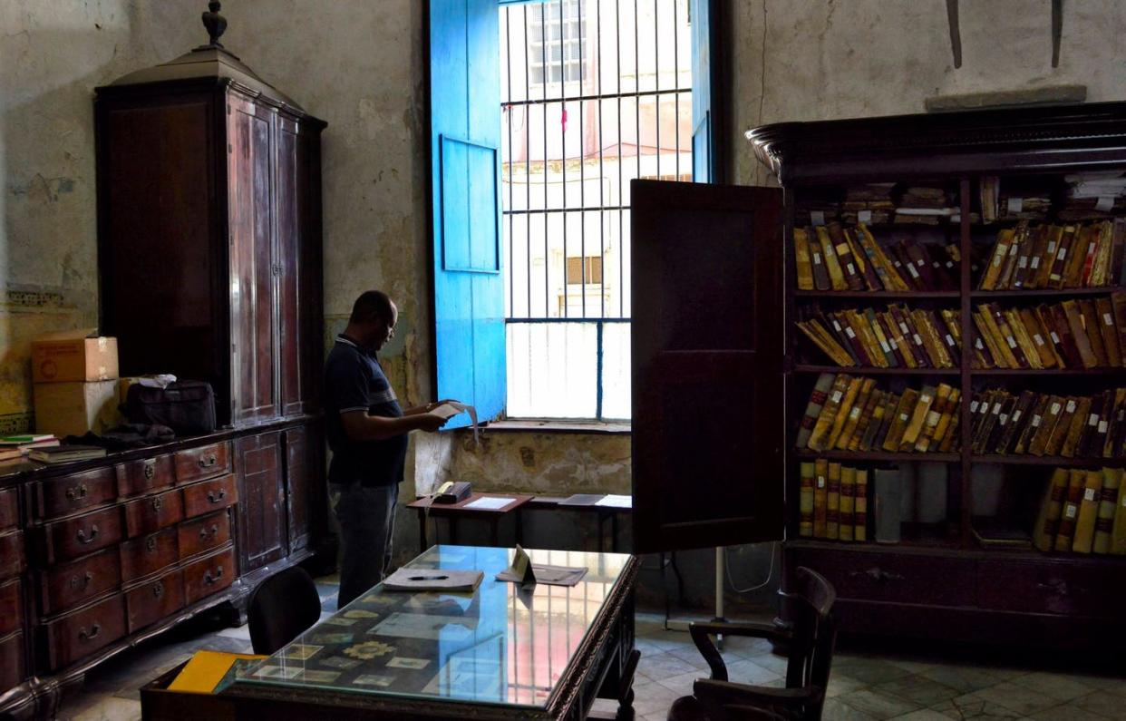 <span class="caption">Team member Felix Knight looks through archives at the Church of Espiritu Santo in Havana, Cuba.</span> <span class="attribution"><span class="source">David LaFevor</span>, <a class="link " href="http://creativecommons.org/licenses/by-sa/4.0/" rel="nofollow noopener" target="_blank" data-ylk="slk:CC BY-SA;elm:context_link;itc:0;sec:content-canvas">CC BY-SA</a></span>