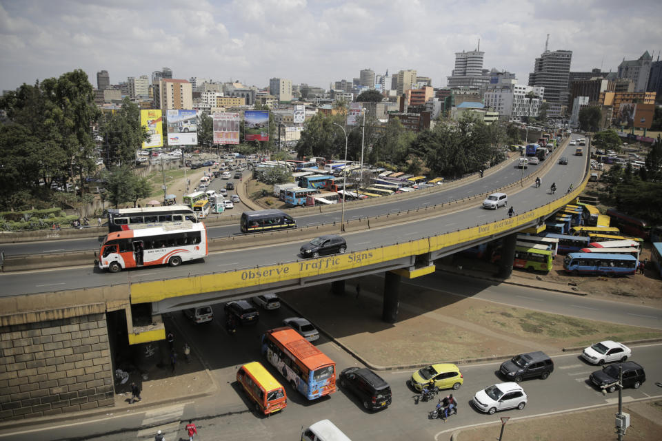 Traffic is seen in the downtown area of the capital Nairobi, Kenya, Friday, Oct. 7, 2022. With the Kenyan shilling down 6% this year, the cost of fuel and imported spare parts is soaring so much that some people are choosing to ditch their cars and take public transportation. (AP Photo/Brian Inganga)