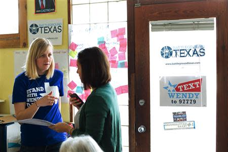 Battleground Texas regional field director Megan Klein (L), talks with volunteer April Crain during a phone call campaign encouraging early voting for Democratic gubernatorial candidate Wendy Davis in Austin, Texas on February 22, 2014. REUTERS/Julia Robinson