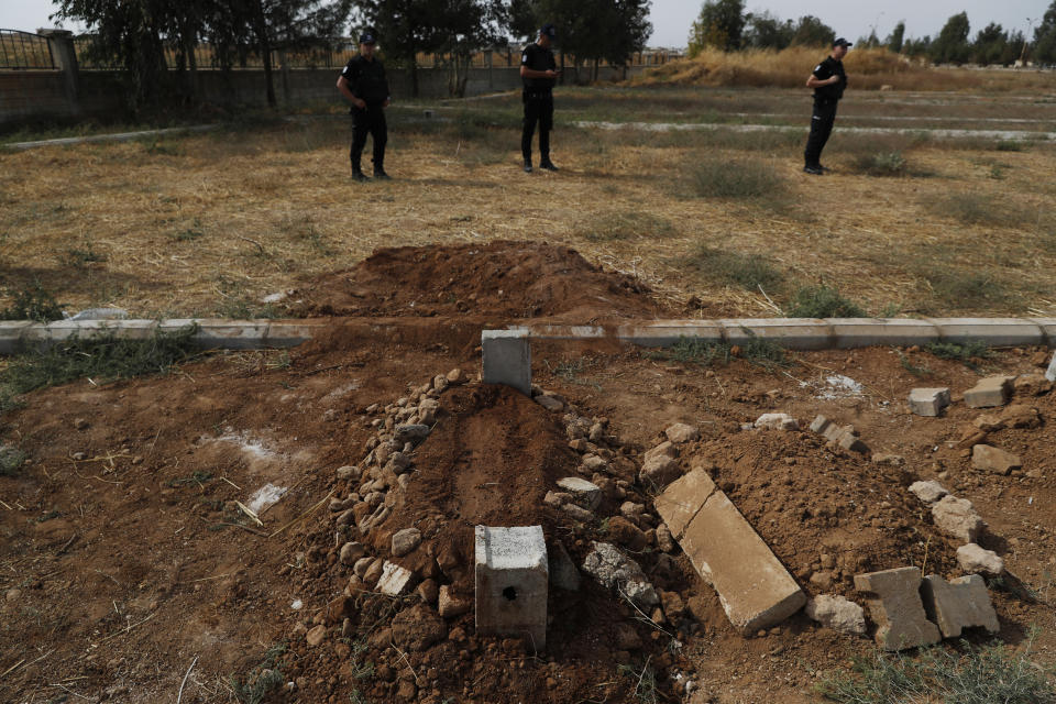 Turkish police officers secure the area of the cemetery where the grave of ten-month-old Mohammed Omar Saar, killed during incoming shelling from Syria Thursday, is following the funeral in Akcakale, Sanliurfa province, southeastern Turkey, at the border with Syria, Friday, Oct. 11, 2019. (AP Photo/Lefteris Pitarakis)