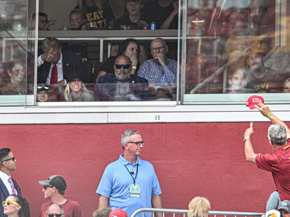 Former President of the United States Donald Trump waves to a supporter while attending the game between the Iowa State Cyclones and the Iowa Hawkeyes at Jack Trice Stadium, Augsut 9, 2023