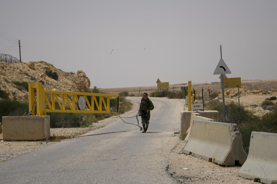 An Israeli soldier closes a gate leading to the border in military base following a deadly shootout in southern Israel along the Egyptian border, Saturday, June 3, 2023. (AP Photo/Tsafrir Abayov)