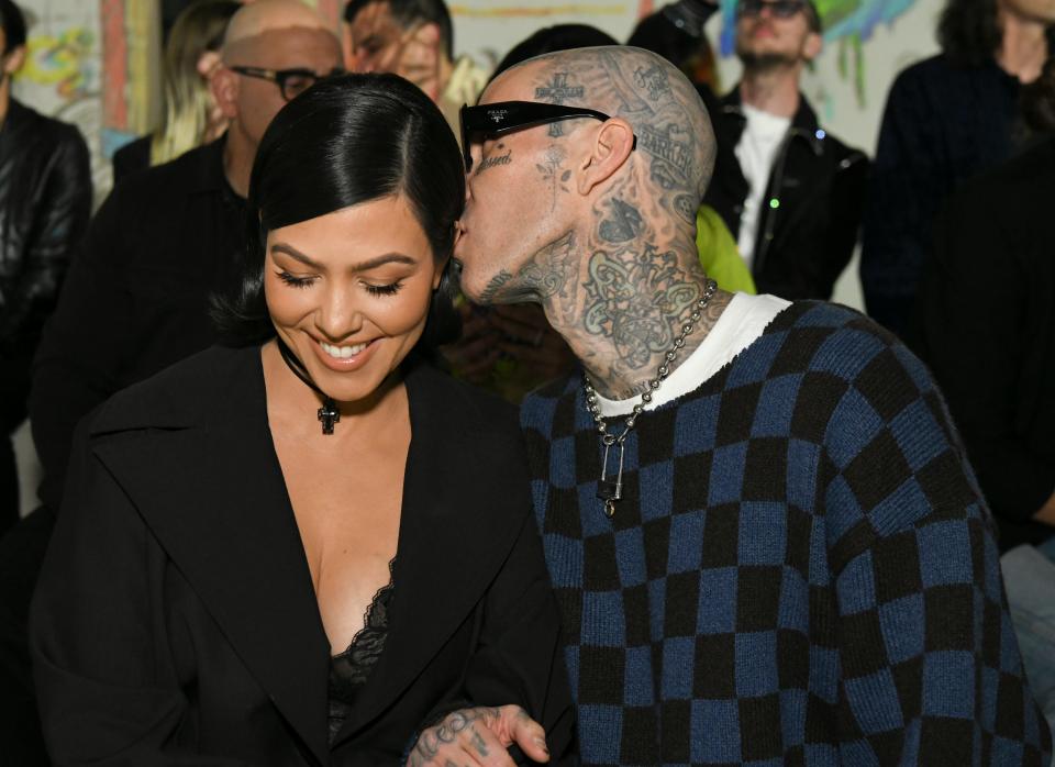 Kourtney Kardashian and Travis Barker attend the AMIRI Autumn-Winter 2022 Runway Show on February 08, 2022 in Los Angeles, California.