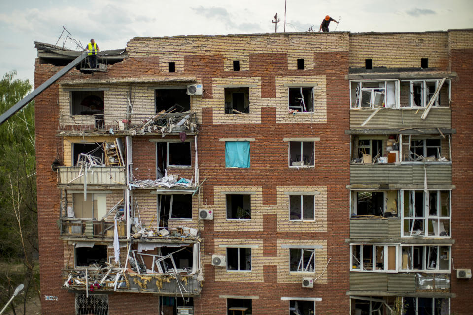 Rescue workers inspect an apartments building damaged in an overnight missile strike in Sloviansk, Ukraine, Tuesday, May 31, 2022. (AP Photo/Francisco Seco)