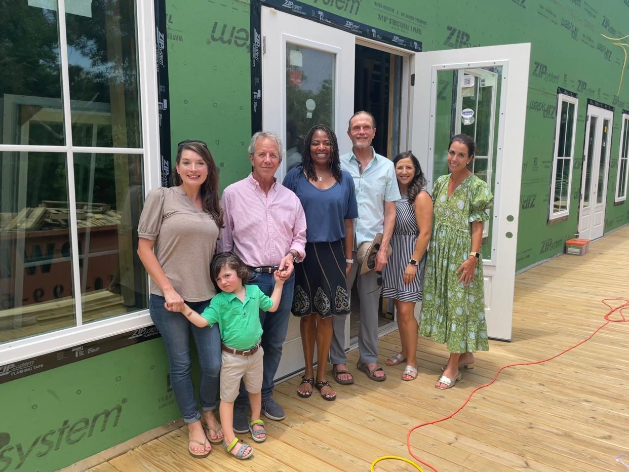 Community and school leaders in front of what will be Bald Head Island Academy. From left: Millicent O'Connor and her son, Mayor Peter Quinn, school co-founder Sheree Vaickus, Dr. Lou Vaickus, Sarah Tennant and Dr. Sabina Bragg.
