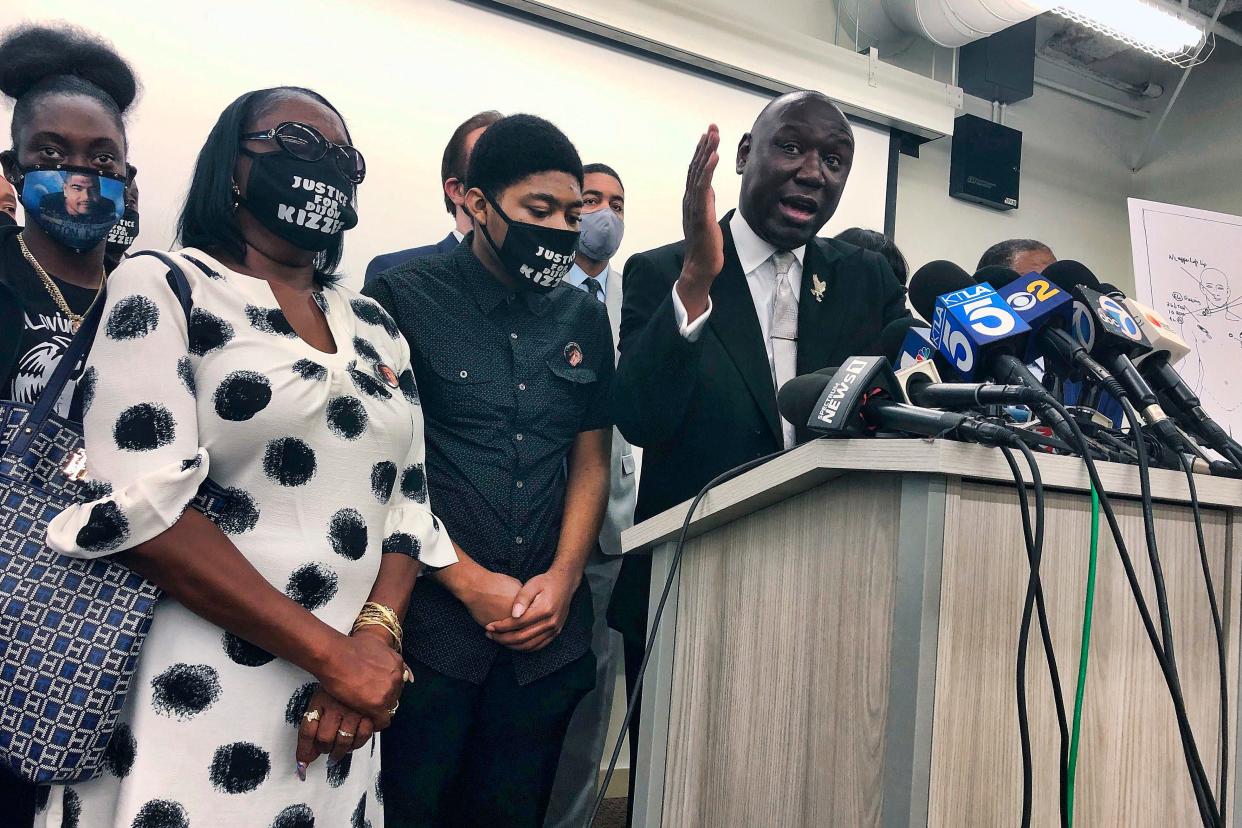 Attorney Benjamin Crump speaks alongside members of Dijon Kizzee's family.