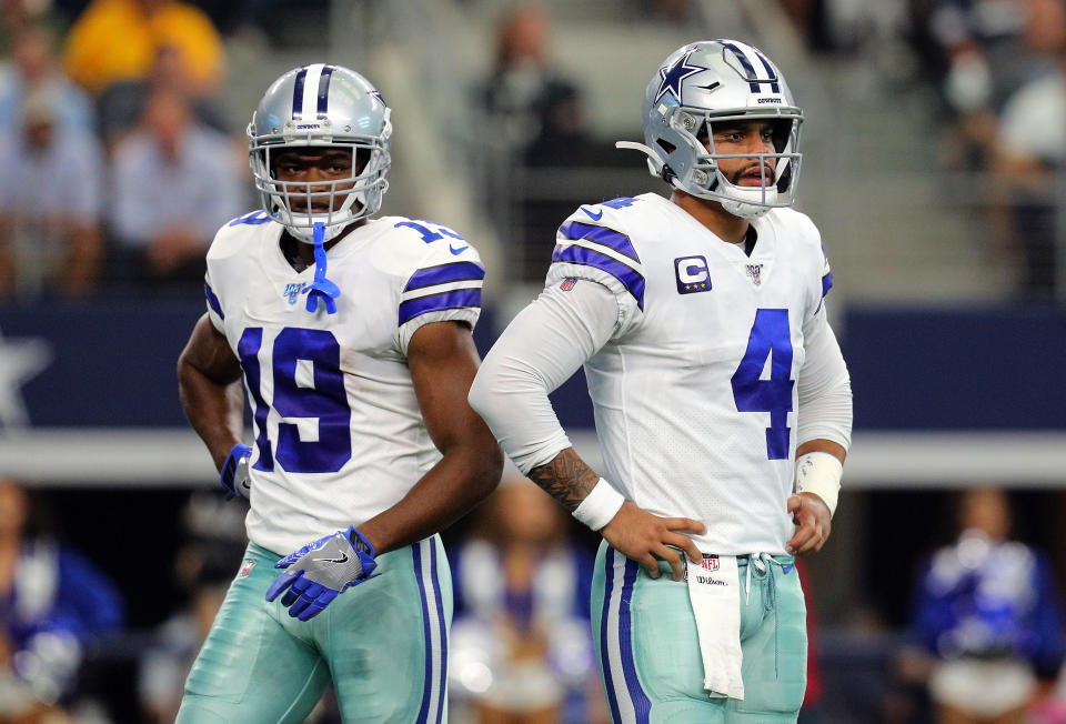 ARLINGTON, TEXAS - OCTOBER 06: Amari Cooper #19 and Dak Prescott #4 of the Dallas Cowboys stand on the field in the first quarter against the Green Bay Packers at AT&T Stadium on October 06, 2019 in Arlington, Texas. (Photo by Richard Rodriguez/Getty Images)