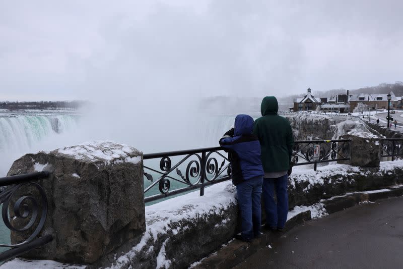 FILE PHOTO: Tourists view mist rising from the Horseshoe Falls while visiting Niagara Falls, Ontario