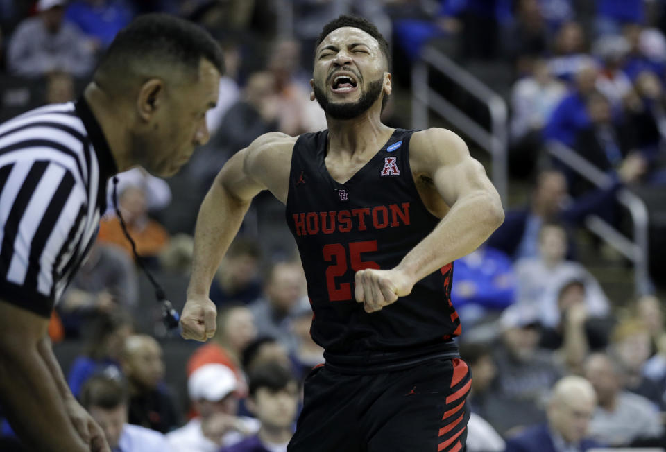 Houston's Galen Robinson Jr. lets out a yell during the second half of a men's NCAA tournament college basketball Midwest Regional semifinal game against Kentucky, Friday, March 29, 2019, in Kansas City, Mo. (AP Photo/Charlie Riedel)