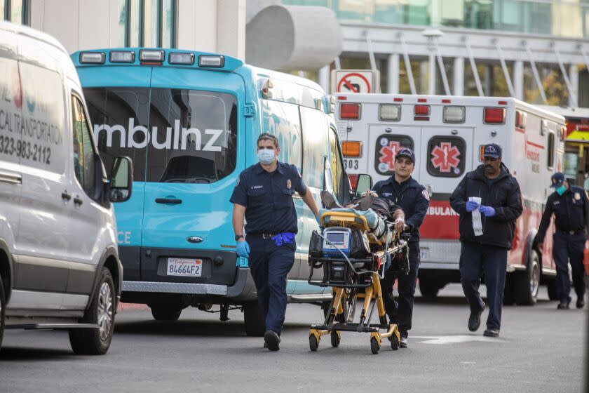Los Angeles, CA - December 16: Ambulances line up outside the emergency department as they transport patients into MLK Community Hospital on Friday, Dec. 16, 2022, in Los Angeles, CA. (Francine Orr / Los Angeles Times)